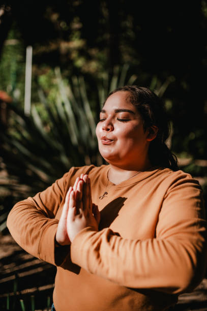 istock Woman meditating at the park 1307824981