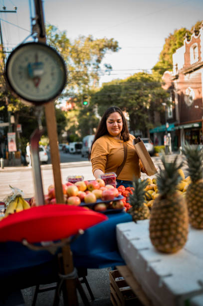 istock Woman buying fruit 1307825050
