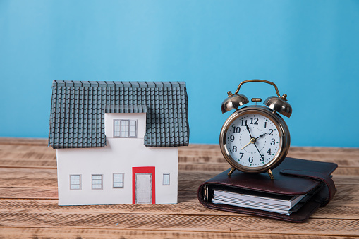 house model with clock on notebook