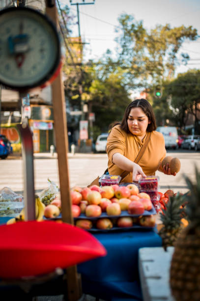 istock Woman buying fruit 1307825365