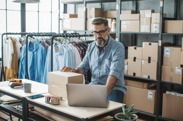 istock Mature man running online store 1307827261