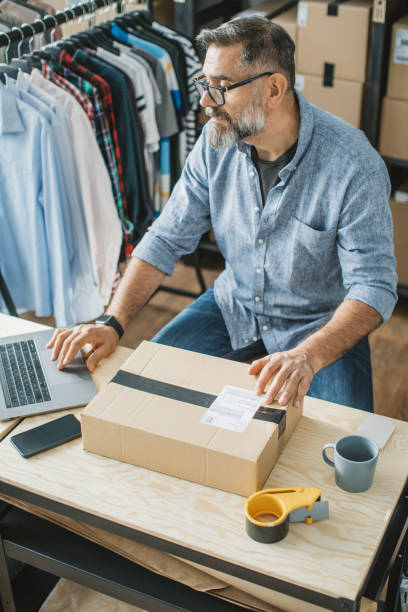 istock Mature man running online store 1307827274