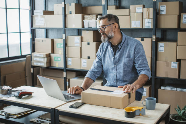 istock Mature man running online store 1307827325