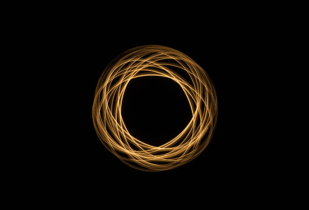 image of random spin shapes made with warm color light painting on black background
