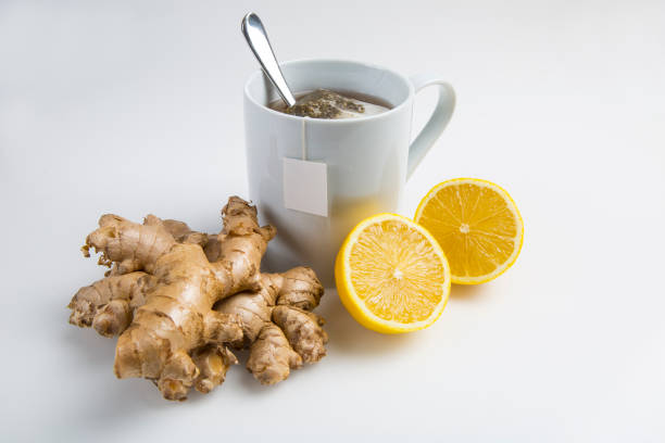istock Cup of hot lemon ginger tea with tea bag and blank label isolated on white background 1307830285