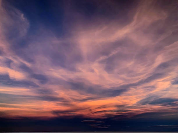 istock Fantastic sunset clouds in night sky. Purple magical cloudscape. Incredible heaven spectacle. 1307830570