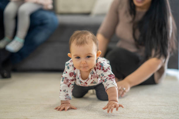 istock Baby Girl Crawling At Home 1307830673