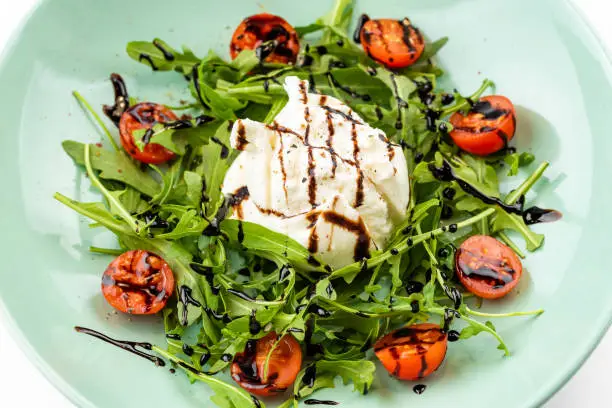 italian buratta with cherry tomatoes and arugula in Rome, Lazio, Italy