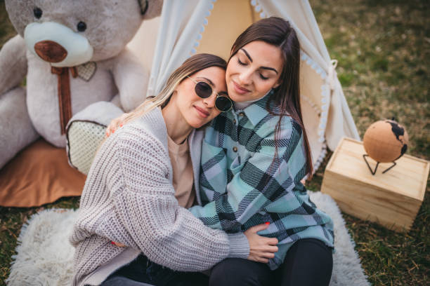istock Two young women enjoying picnic in nature 1307834030
