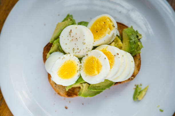 istock Hard Boiled Eggs Sliced with Avocados on Toast 1307834259