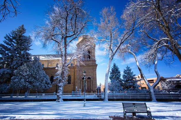 Santa Fe, NM: Saint Francis Cathedral in the snow, side view. The Cathedral Basilica of St Francis of Assisi, a block from the historic Santa Fe Plaza in New Mexico, was built by Archbishop Lamy between 1869 and 1886 in the Romanesque Revival style.