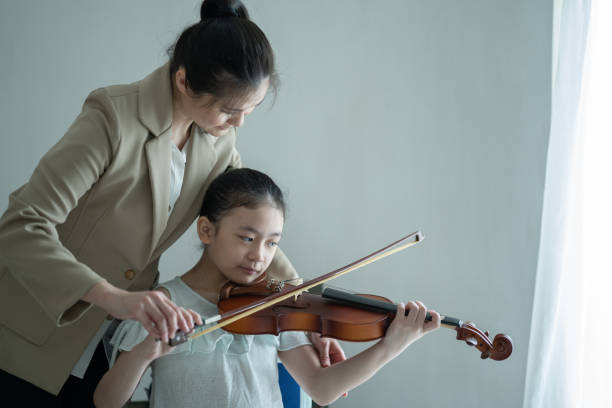 istock Young little girl learning to play violin 1307838711