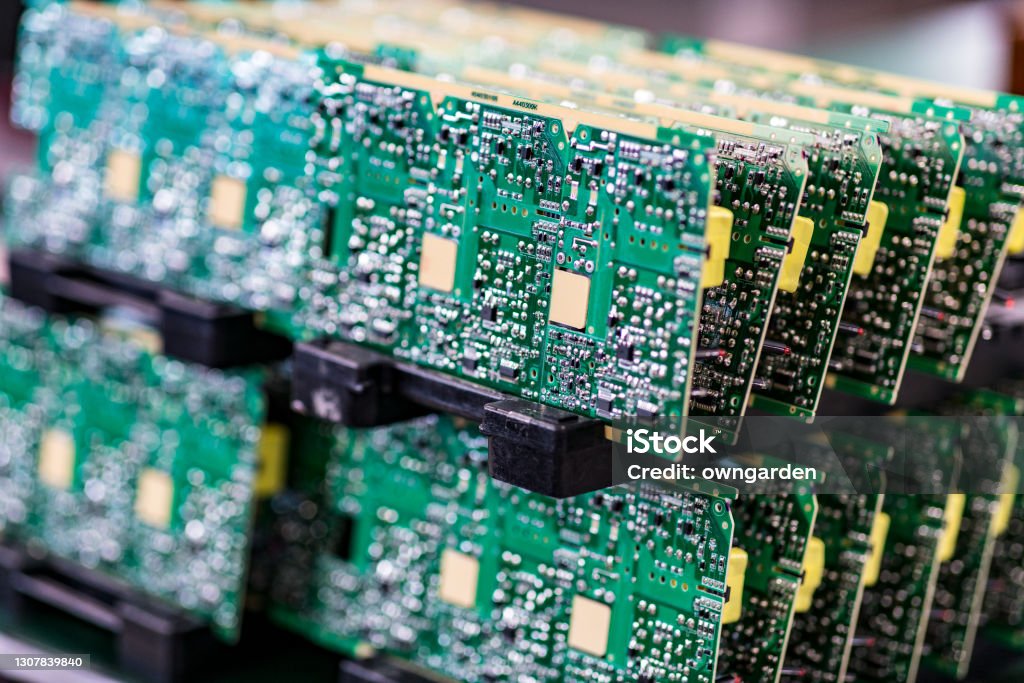 Circuit board with electronic components Blurred macro image of a row of microchips. Computer Chip Stock Photo