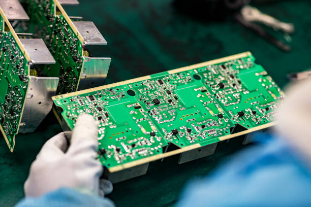 il lavoratore sta lavorando sulla catena di montaggio - service electronics industry circuit board capacitor foto e immagini stock
