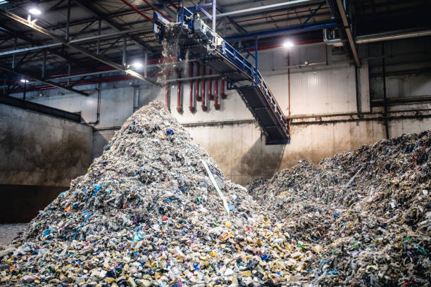 istock Recyclables Falling From Conveyor Belt on Growing Pile 1307840855