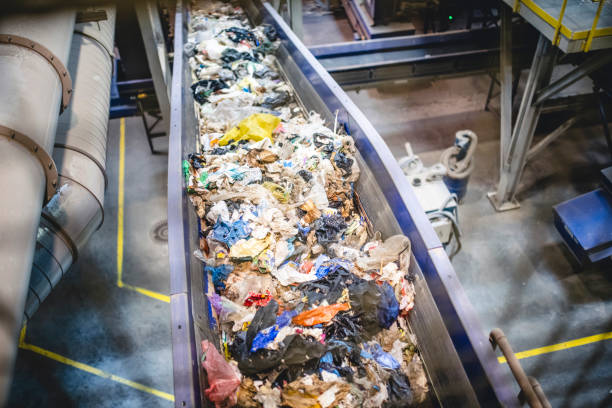 istock Conveyor Belt Filled with Recyclables in Waste Facility 1307840863