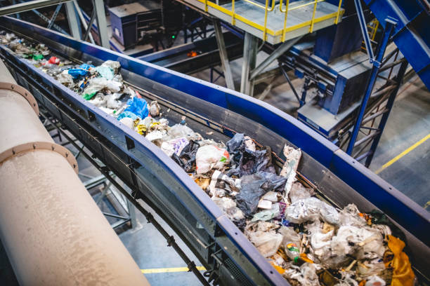 istock Recyclable Garbage Moving on Conveyor Belt in Waste Facility 1307840864
