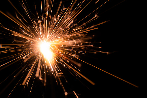 Sparks of sparklers on a black background abstract New Year background
