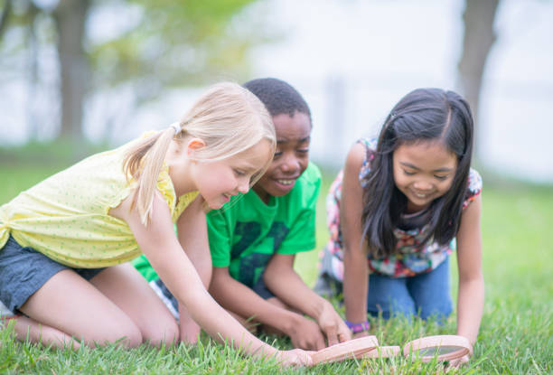 istock Three Children Looking For Insects Outdoors 1307842997