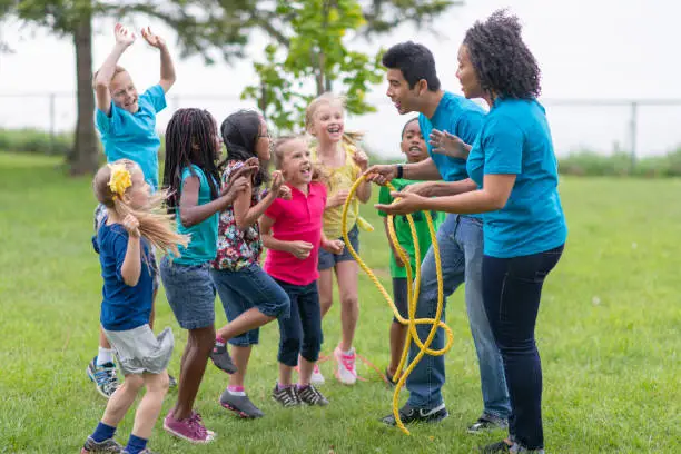 Photo of Camp Counsellors and Children Getting Ready for Tug-of-War Game