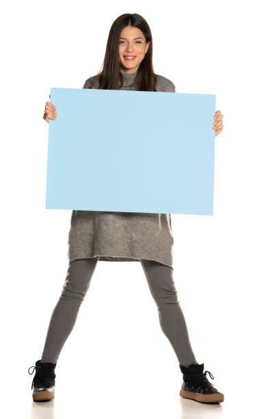 istock young beautiful happy woman holding a blue empty board 1307843597