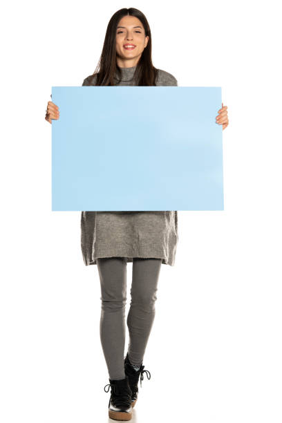 istock young beautiful happy woman holding a blue empty board on white background 1307843611