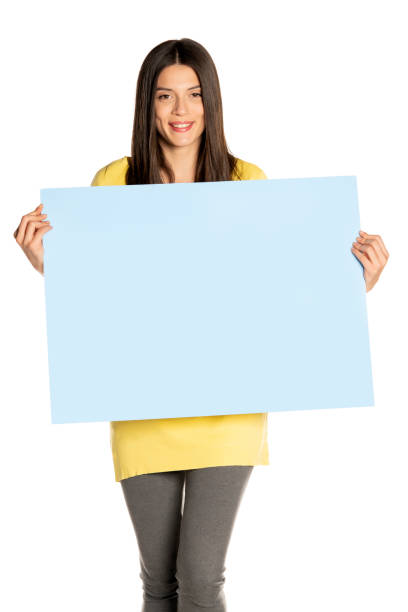 istock young beautiful happy woman holding a blue empty board 1307843623