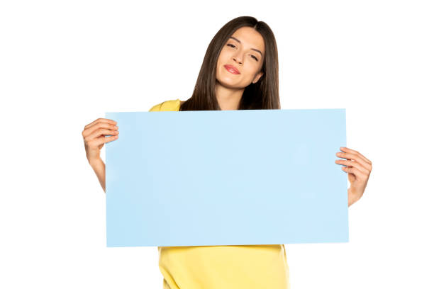 istock young beautiful happy woman holding a blue empty board on white background 1307843633