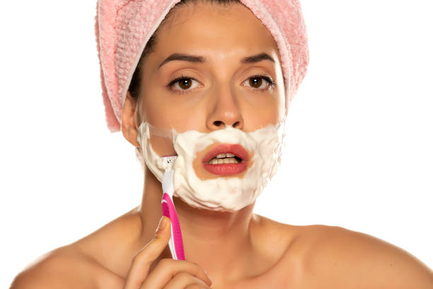 istock Young beautiful woman shaves her face 1307844480