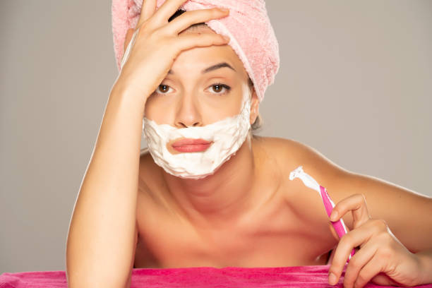 istock Young disappointed woman shaves her face 1307844486