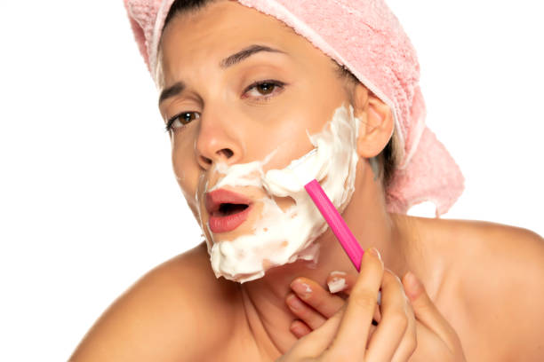 istock Young beautiful woman shaves her face 1307844490