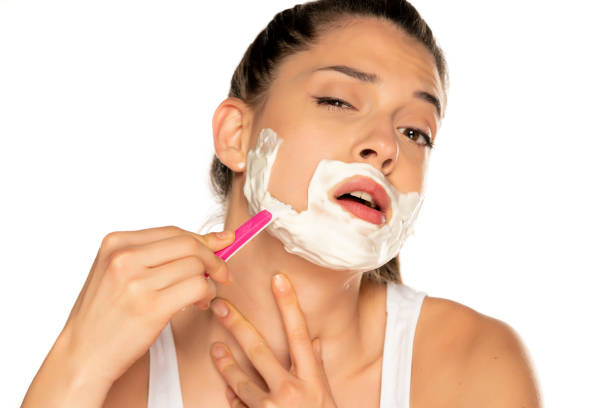 istock Young beautiful woman shaves her face 1307844542