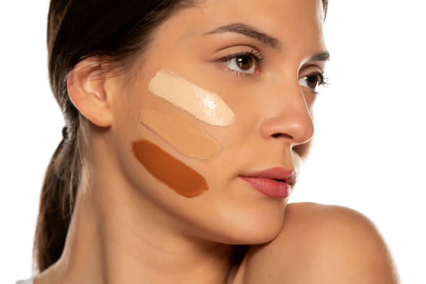 istock Young woman with three different tones of liquid foundation on her face 1307844549