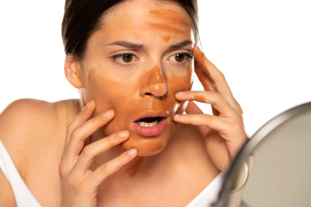 istock Young shocked woman with wrong makeup base on her face 1307844571