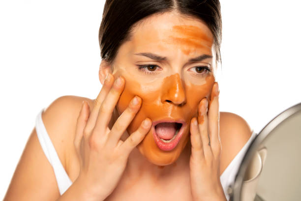 istock Young shocked woman with wrong makeup base on her face 1307844573