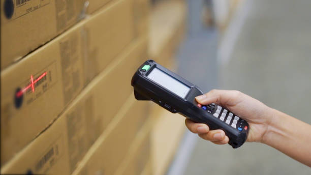istock Close up hand scanning products with barcode scanner in warehouse. 1307848688