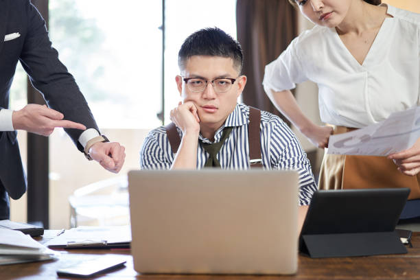 Asian male businessman chased by workload and deadlines Asian male businessman chased by workload and deadlines cruel stock pictures, royalty-free photos & images