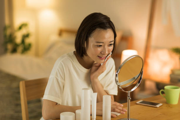 young woman spending time at home - facial cleanser imagens e fotografias de stock