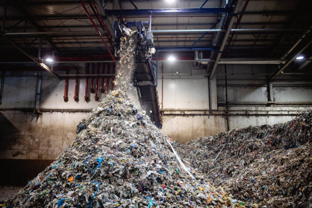 istock Recyclables Falling From Conveyor Belt on Growing Pile 1307852271