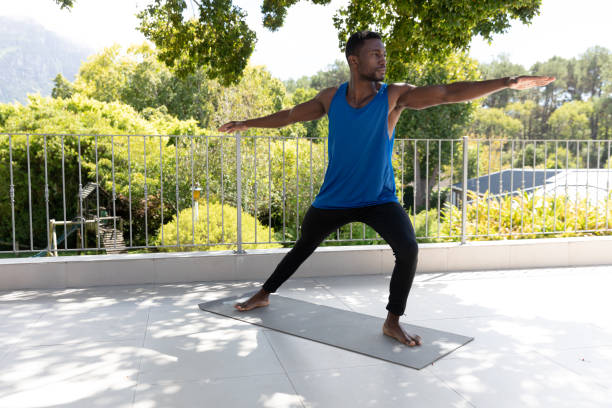 istock African american man exercising practicing yoga on sunny garden terrace 1307854590