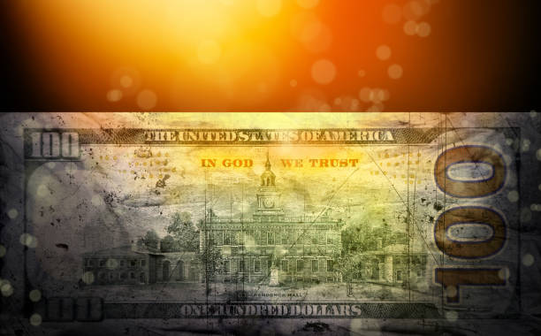 Close up conceptual image of American one hundred dollar bill under spotlight