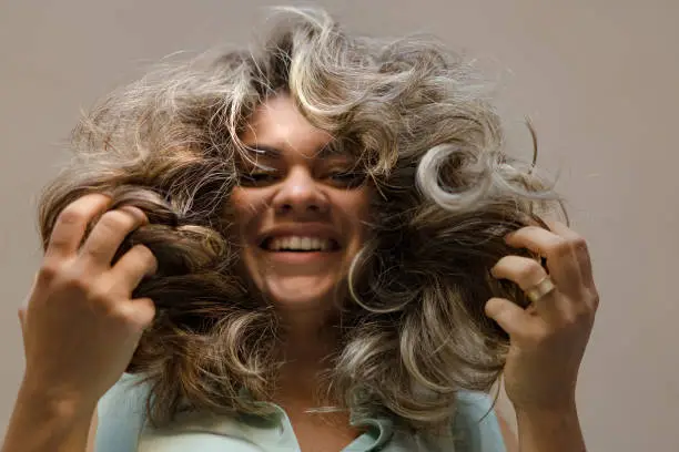 Photo of Laughing woman with hands in hair