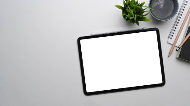 istock Above view of mock up digital tablet with empty screen on white background. 1307860765