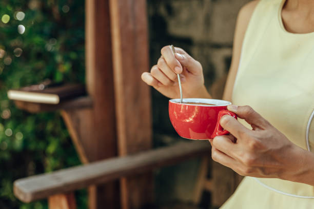 istock hand use spoon mix coffee in the morning. 1307865504
