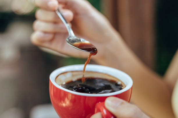 istock hand use spoon mix coffee in the morning. 1307865528