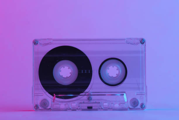 istock Retro audio cassette in trendy neon light. Gradient pink-blue glow. Concept art. Minimalism 1307867239