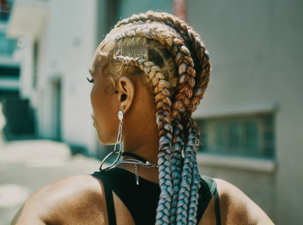 Even my braids have a bit of sass Cropped shot of an unrecognizable woman standing alone and posing outside during the day weaving stock pictures, royalty-free photos & images