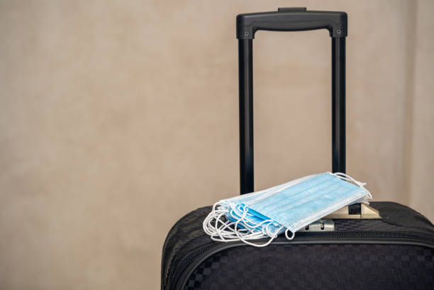 istock Medical masks on a black suitcase. 1307868554