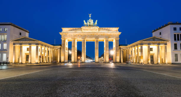 istock Panorama of the illuminated Brandenburg Gate 1307868623
