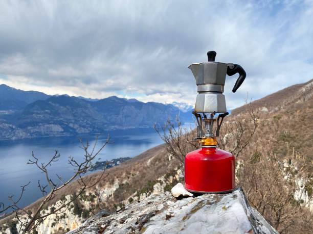 istock Moka coffee on portable camping stove with mountains panorama 1307869610